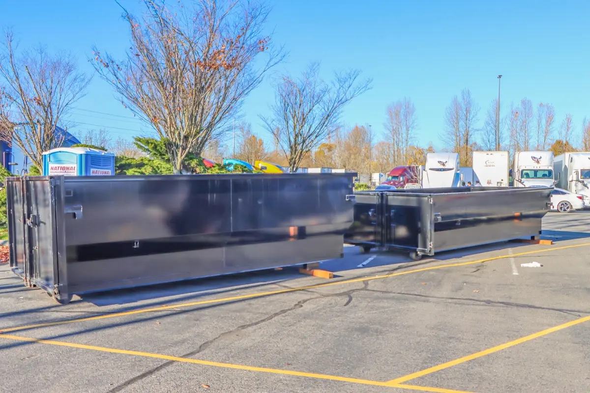 Professional dumpster rental service with roll-off container on residential driveway in Mahtomedi